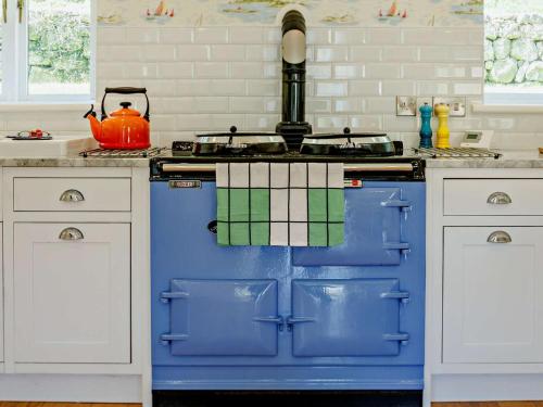 a blue stove top oven in a kitchen at 6 Bed in Abergele oc-91054 in Llanddulas