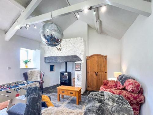 a living room with two chairs and a fireplace at 6 Bed in Harlech oc-91546 in Harlech