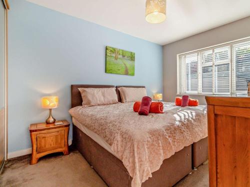 a bedroom with a bed with red pillows on it at 2 Bed in Cromer oc-29556 in Cromer
