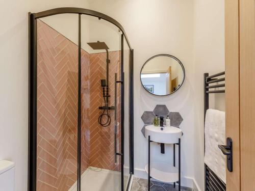 a bathroom with a shower and a sink and a mirror at 14 Bed in Welshpool oc-90568 in Berriew