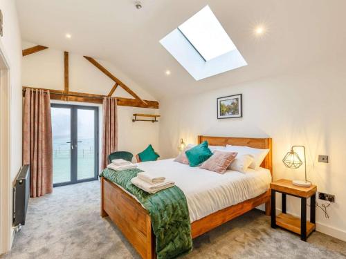 a bedroom with a large bed and a skylight at 14 Bed in Welshpool oc-90568 in Berriew