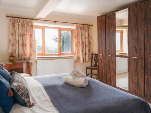a bedroom with a bed with a towel on it at 5 Bed in Aberystwyth oc-58889 in Llanrhystyd