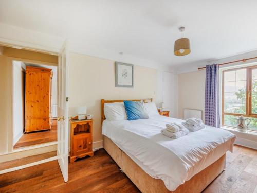 a bedroom with a large bed and a window at 3 Bed in Corwen oc-90459 in Corwen