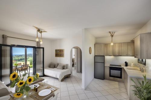 a kitchen and a living room with a couch at Kefalonian Oneira Villas in Mousata