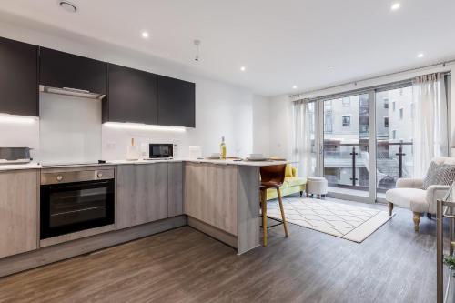 an open kitchen with a table and a living room at Little Sea - Moments from Waterfront Restaurants in Poole