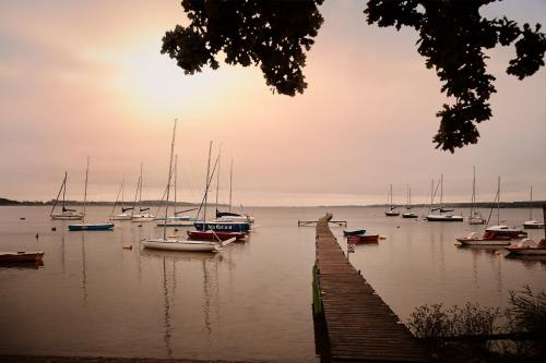 a group of boats docked in a body of water at Dworek Hetmanski in Stargard