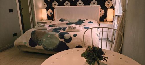 a bedroom with a cow print bed with two tables at ROMAnce Cosimato Trastevere B&B in Rome