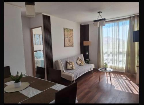 a living room with a couch and a table at Departamento COPAYAPU in El Cerrillo