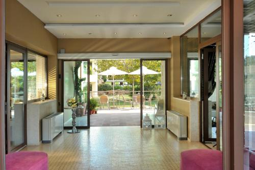 a hallway with sliding glass doors and a patio at Sani Polyastron Hotel & Spa in Sani Beach