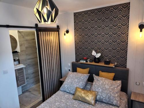 a bedroom with a bed and a chandelier at chambre Marseille pas lon de saint Charles et vieux port in Marseille