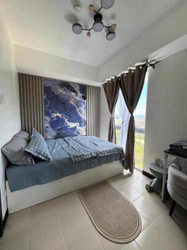 a bedroom with a bed and a window at JI Homestaycation in Manila