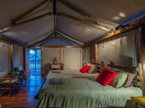 a bedroom with two beds in a tent at Iphofolo Lodge & Tented Camp in Vivo