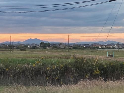 a field with a soccer ball in a field at Narita Airport Samurai Guesthouse -In front of Train Station- in Katori