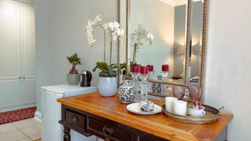 a dressing table with a mirror and flowers on it at Upper Classic in Clarens