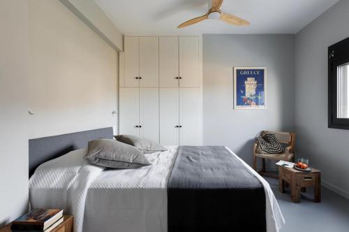 a bedroom with a bed and a ceiling fan at Ammos Boutique Villa in Elafonisos