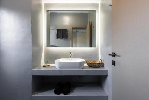 a bathroom with a sink and a mirror at Ammos Boutique Villa in Elafonisos
