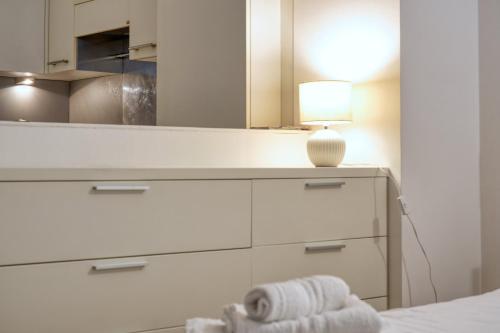 a bedroom with a dresser with a mirror and a lamp at Sergio's house in Como