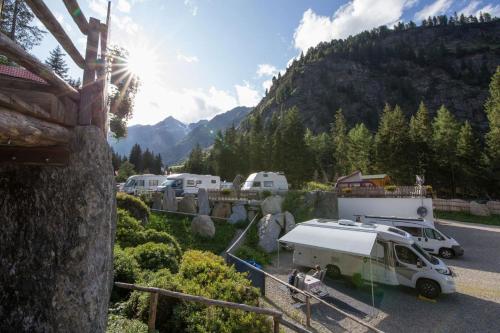 a group of vehicles parked in a parking lot at Camping Bergkristall in Moso
