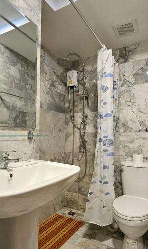 a bathroom with a sink and a toilet and a shower at PB329 Phuket's best oceanfront studio in Ban Mai Salae