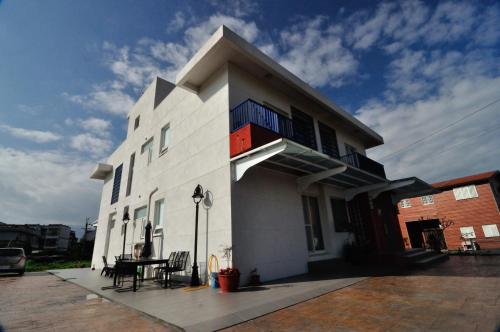 a white building with a table in front of it at ChaoPingJia Fengge Guesthouse in Wujie