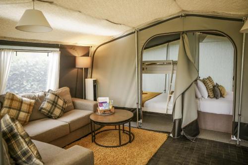 a living room with a couch and a table in a caravan at King Fisher in Nantmel