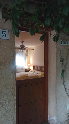a bedroom with a bed in the middle of it at Las Lucías, experiencias de ecoturismo in Navatrasierra