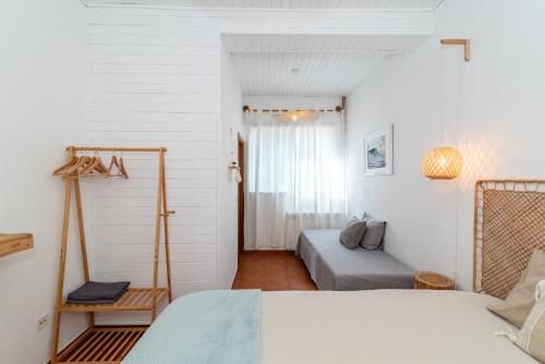 a bedroom with two beds and a window at Ticket2Surf in Palheiros da Tocha