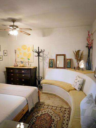 a bedroom with two beds and a dresser at The Windmill, Garden House in Llubí