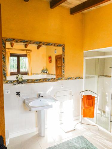 a bathroom with a sink and a mirror at The Windmill, Garden House in Llubí