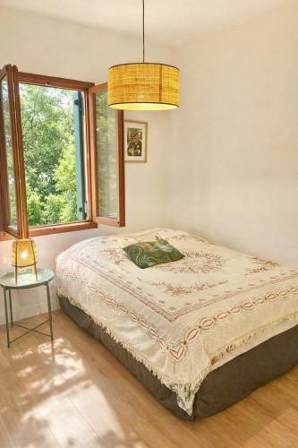 a bedroom with a bed and a window at CAVALOC T2 terrasse vue colline in Cavalaire-sur-Mer