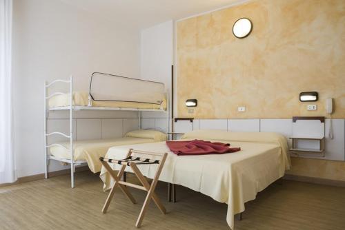 a room with two beds and a shelf at Hotel Alba in Gabicce Mare