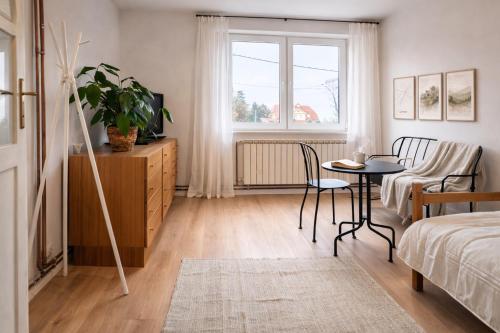 a bedroom with a table and a bed and a window at Quiet & Cozy Apartment near Samobor - Terrace, Parking, Close to Zagreb & Tabor in Samobor