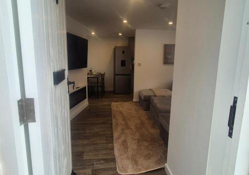 a living room with a couch and a table at Spacious & Luxury 2BR Flat in Calverton in Calverton