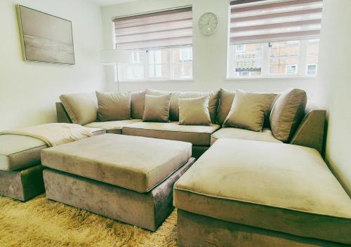 a living room with a couch and ottoman at Spacious & Luxury 2BR Flat in Calverton in Calverton