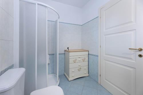 a bathroom with a toilet and a shower and a sink at Sale Marino - Goelba in Capoliveri