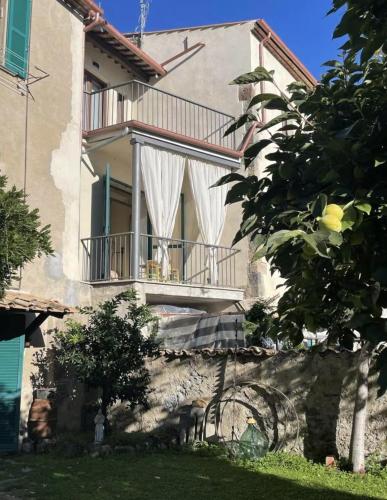 a large house with a balcony and a yard at Lo studio di Gabriella in Bolsena