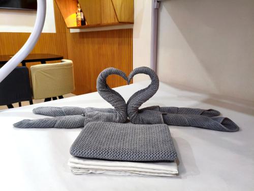 two metal swans forming a heart on a table at SNOW Studio Apartment - Near Clark International Airport in Mabalacat