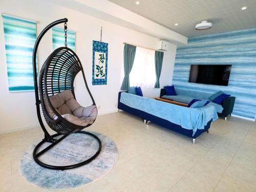a room with a swing and a bed in it at YUTO Ishigakijima in Ishigaki Island