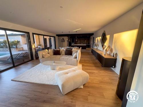 a living room with a couch and a table at Villa des Oliviers in Flavin