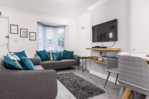 a living room with a couch and a table at Magnolia House - Beautiful Townhouse in Old Town Poole in Poole
