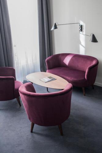 a living room with two couches and a table at Hôtel de Tourny - Boutique Hôtel Bordeaux Centre in Bordeaux
