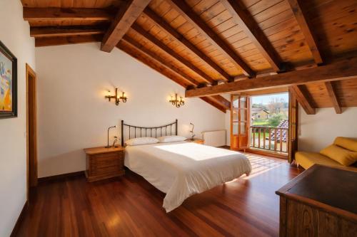 a bedroom with a large bed and a balcony at Playa de La Franca, jardín y WiFi - Casa Freya in La Franca