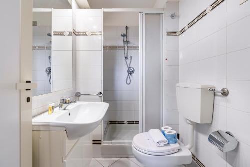 a bathroom with a toilet and a sink and a shower at Corso Double in Florence
