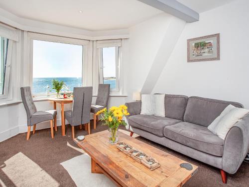 a living room with a couch and a table at Mamhead View in Exmouth