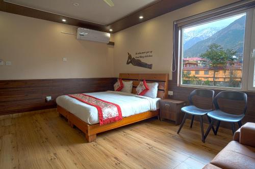 a bedroom with a bed and a large window at Hotel Buddha House Himalayan Brothers in Dharamshala