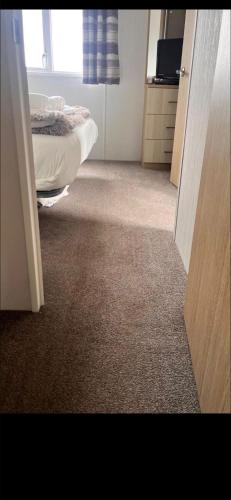 an open door to a bedroom with a bed in it at Trailer by the sea in Millom