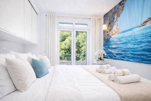 a bedroom with a large white bed with towels on it at Pula Paradise in Pula