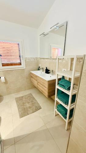 a bathroom with a tub and a sink and a mirror at Casa Paradiso La Cinta San Teodoro in San Teodoro