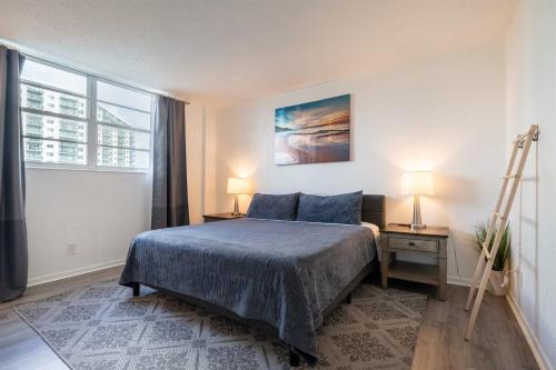 a bedroom with a bed and two lamps and a ladder at Ocean Reserve Condominium in Miami Beach