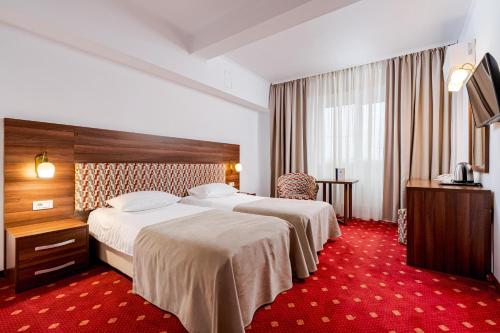 Giường trong phòng chung tại Hotel Minerva